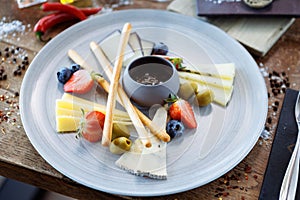 Cheese platter for two: Goat cheese cream, gorgonzola, camembert, grissini and fig jam. Delicious healthy Italian