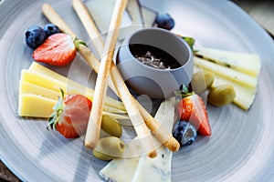 Cheese platter for two: Goat cheese cream, gorgonzola, camembert, grissini and fig jam. Delicious healthy Italian