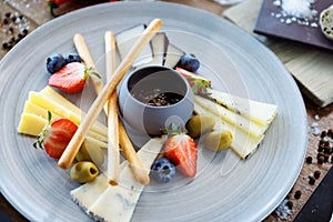 Cheese platter for two: Goat cheese cream, gorgonzola, camembert, grissini and fig jam. Delicious healthy Italian