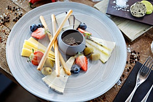 Cheese platter for two: Goat cheese cream, gorgonzola, camembert, grissini and fig jam. Delicious healthy Italian