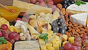 Cheese platter with various types of cheese - parmesan brie roquefort camembert maasdam. Gourmet appetizer, snack food.
