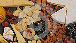 Cheese platter with various types of cheese - parmesan brie roquefort camembert maasdam. Gourmet appetizer, snack food. Assortment