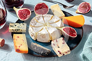 Cheese platter with wine and figs, close-up shot