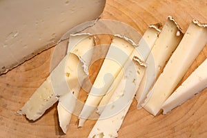 cheese produced in the Italian region of Veneto on a wood