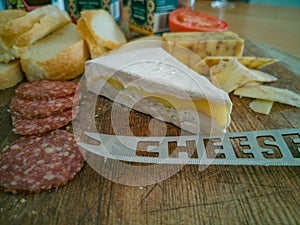Cheese and salami on wood serving board