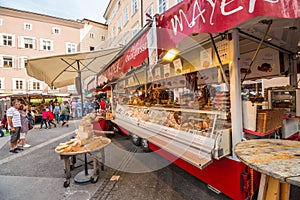 Cheese, sausages and other products foa sale on the market at Universitatsplatz in the old town of Salzburg, Austria