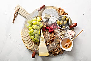 Cheese and snacks plate on white background