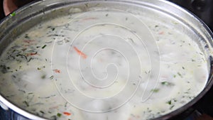 Cheese soup with herbs cooked in pan