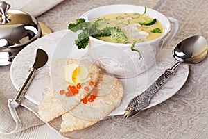 Cheese soup in a tureen on the table close-up cooking recipe