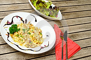 Cheese spaetzle on a plate with a salad photo