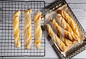 Cheese sticks made of puff pastry on a baking grate