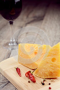 Cheese on the table with glass of wine