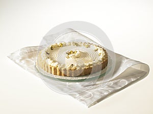 Cheese Tart with pistachio nuts and whipped cream