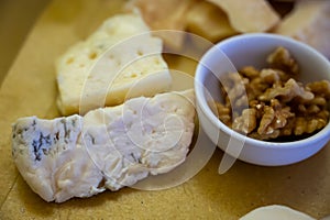 Cheese tasting, piece of italian blue cheeses gorgonzola dolce and picante with blue mold from north of Italy close up photo