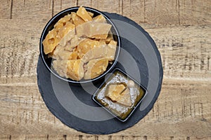 Cheese tasting, small pieces of old Dutch hard cheese and bowl with homemade dill-mustard sauce