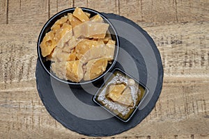 Cheese tasting, small pieces of old Dutch hard cheese and bowl with homemade dill-mustard sauce