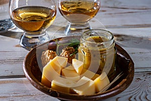 Cheese tasting, small pieces of old Dutch hard cheese and bowl with homemade dill-mustard sauce