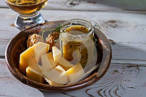 Cheese tasting, small pieces of old Dutch hard cheese and bowl with homemade dill-mustard sauce