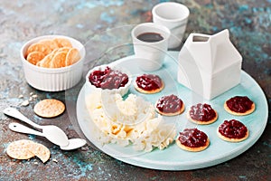 Cheese Tete de Moine with crackers and cranberry jam photo