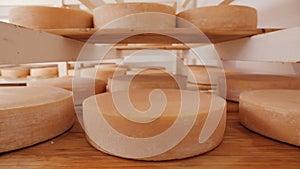 Cheese wheels maturing on shelves - camera slide