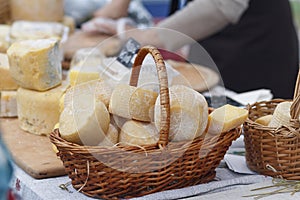 Cheese in a wicker basket on the market counter