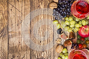 Cheese, wine, baguette grapes figs honey and snacks on the rustic wooden table top with copy space.