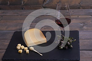 Cheese and wine lie on a stone
