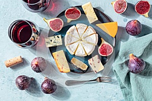 Cheese and wine tasting, cheese platter with figs, a flat lay