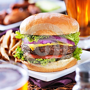 Cheeseburger with beer and french fries close up