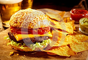 Cheeseburger with beer and nacho snacks