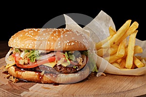 Cheeseburger burger with french fries and sauce.