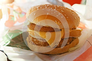 Cheeseburger with double cutlet close-up in a fast food restaurant