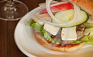 Cheeseburger with french cheese including,lettuce,oignons and tomato