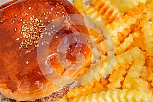 Cheeseburger and french fries fluted close-up, selective focus