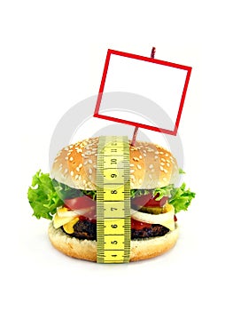 A cheeseburger with measuring tape