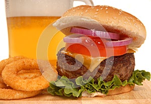 Cheeseburger with onion rings and beer