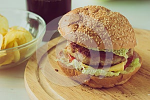 Cheeseburger on wooden plate