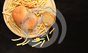 Cheeseburgers and french fries on a cutting board, top view. Fast food.