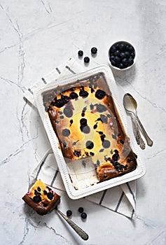 Cheesecake berries on kitchen table on concrete background