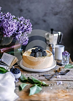 Cheesecake with blackberry berries on a wooden table