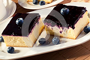Cheesecake with blueberries and a cap of coffee