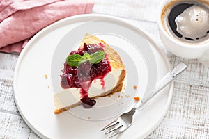 Cheesecake With Cherry Sauce On Plate