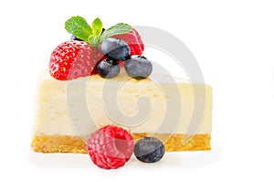Cheesecake with fresh berries and mint leaves isolated
