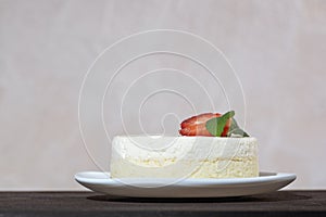 Cheesecake with fresh strawberries and mint on white dish. Delicate cheese dessert
