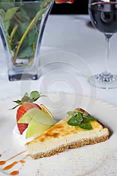 Cheesecake a la carte with roses and wine photo