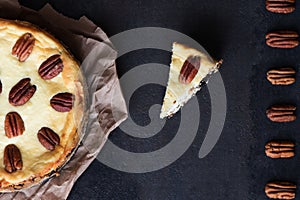 Cheesecake with pecan nuts on a black background