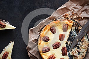 Cheesecake with pecan nuts on a black background