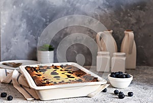 Cheesecake with ricotta on kitchen table on concrete background