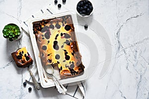 Cheesecake with ricotta on kitchen table on concrete background