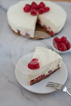 Cheesecake slice with raspberries on a plate